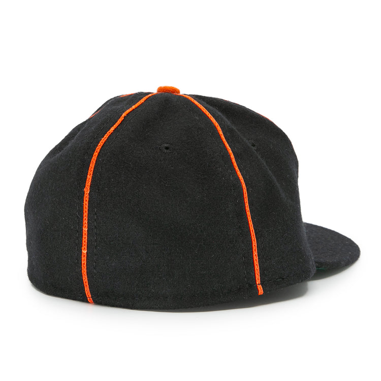The EFF Montreal Black Panthers 1936 Vintage Ballcap in black is shown from the back, featuring orange seam stitching and a small orange top button, inspired by classic Quebec Provincial League baseball cap styles.
