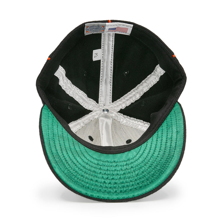 Inside view of the EFF Montreal Black Panthers 1936 Vintage Ballcap shows a green underbrim, white seams, and size 7 1/4 label, plus Made in USA and Genuine Merchandise tags reflecting its classic Quebec Provincial League roots.