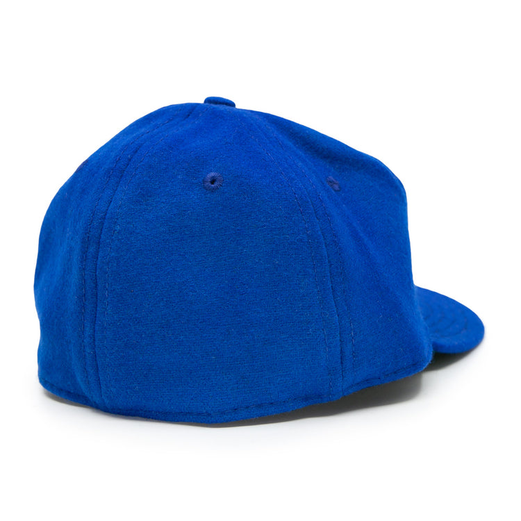 The EFF Memphis Red Sox 1944 Vintage Ballcap, shown from the back, features a royal blue wool build with a rounded crown and stitched panels, evoking classic Negro American League style. The curved brim faces away from the viewer.