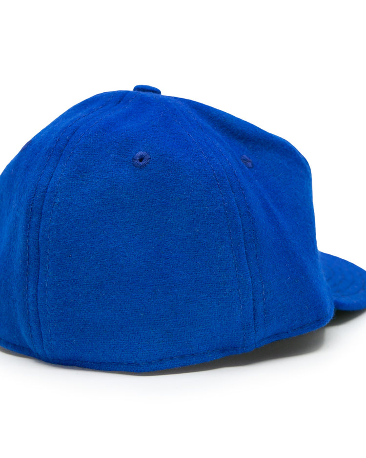The EFF Memphis Red Sox 1944 Vintage Ballcap, shown from the back, features a royal blue wool build with a rounded crown and stitched panels, evoking classic Negro American League style. The curved brim faces away from the viewer.