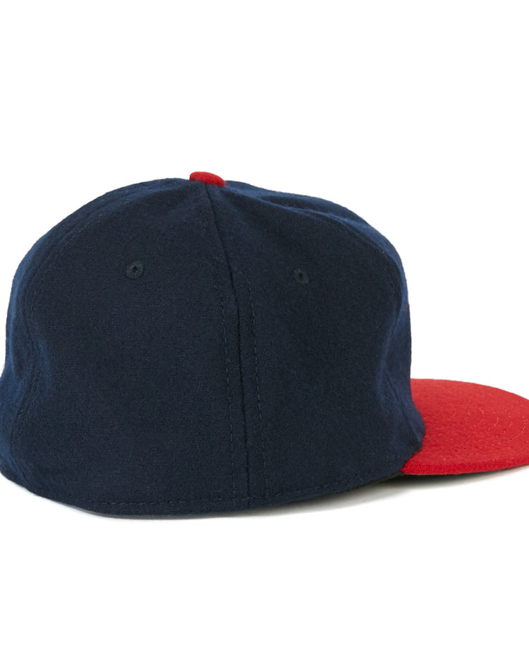 The EFF Milwaukee (AA) 1951 Vintage Ballcap is an authentic reproduction wool cap in navy blue, with a red visor and top button, shown from the back at a slight angle.