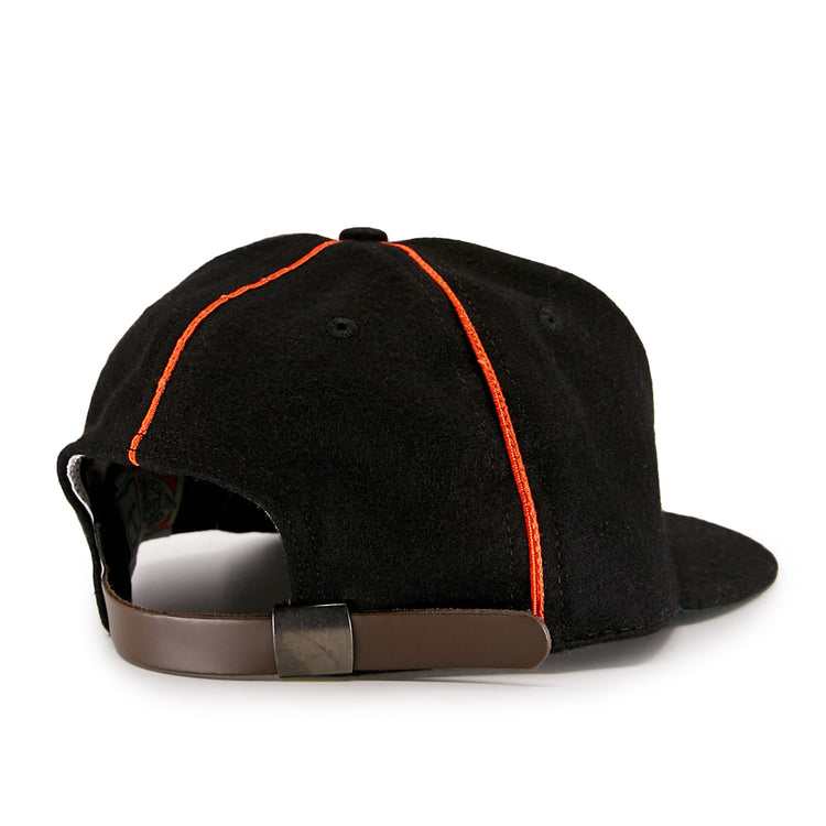 The EFF Wichita Monrovians 1925 Vintage Ballcap features red stitching and a brown adjustable strap with metal clasp, shown from the back. Inspired by classic Negro Leagues style.