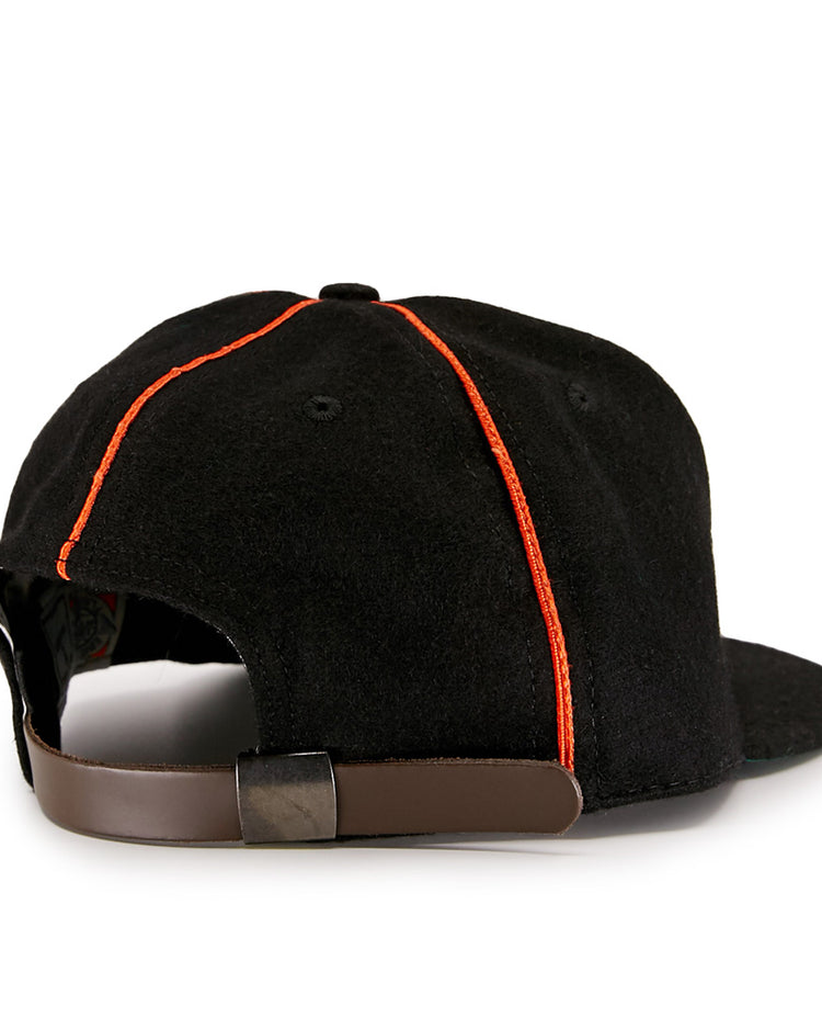 The EFF Wichita Monrovians 1925 Vintage Ballcap features red stitching and a brown adjustable strap with metal clasp, shown from the back. Inspired by classic Negro Leagues style.