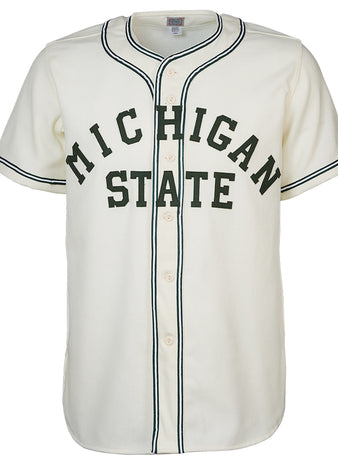 The EFF Michigan State 1940 Home Jersey is a white baseball jersey with black trim, front buttons, and MICHIGAN STATE in large dark green letters across the chest for a vintage collegiate look.