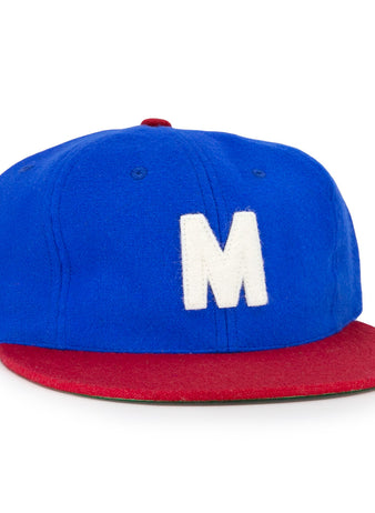The EFF Montreal Royals 1935 Vintage Ballcap features a blue crown, red brim, and a large white M on the front, inspired by the classic 1935 team design.