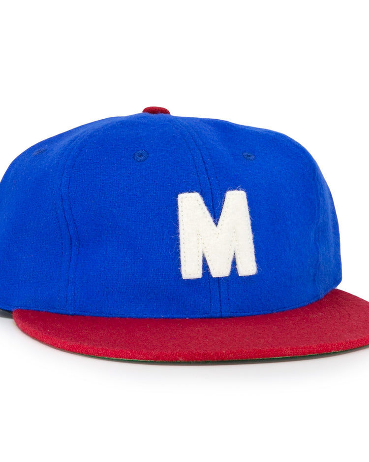 The EFF Montreal Royals 1935 Vintage Ballcap features a blue crown, red brim, and a large white M on the front, inspired by the classic 1935 team design.