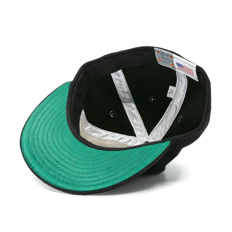 The EFF Nashville Stars 2020 Vintage Ballcap in black is shown from underneath, displaying a green underbrim, silver interior seams, a size label, and a tag featuring the American flag.