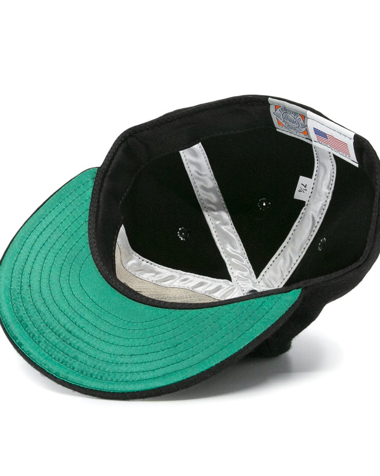 The EFF Nashville Stars 2020 Vintage Ballcap in black is shown from underneath, displaying a green underbrim, silver interior seams, a size label, and a tag featuring the American flag.