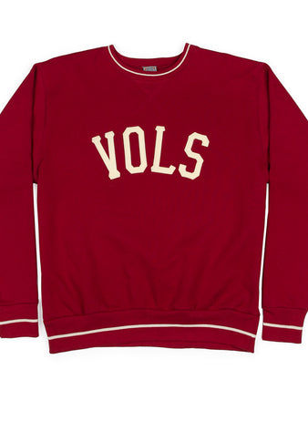 The Nashville Vols Vintage Crewneck Sweatshirt by EFF is a red USA-made top with VOLS in bold white letters across the chest and crisp white trim on the collar, cuffs, and waistband.