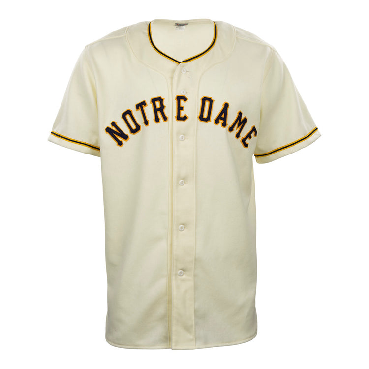 The EFF University of Notre Dame 1956 Home Jersey is a vintage-style cream flannel baseball jersey with black and gold trim and bold Notre Dame lettering across the chest, inspired by the 1956 button-down original.