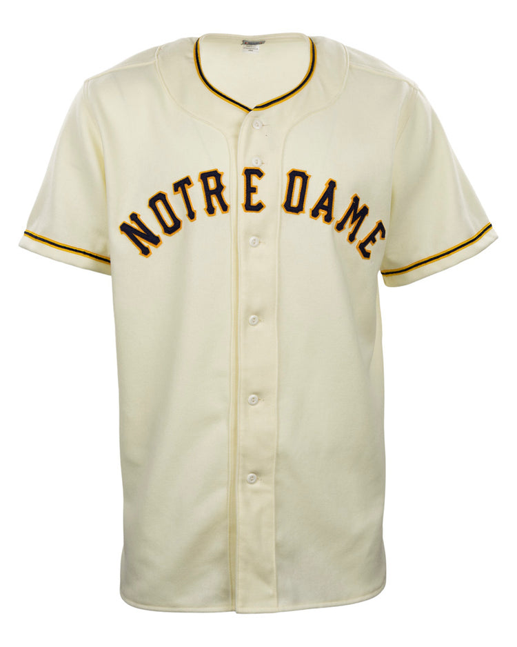 The EFF University of Notre Dame 1956 Home Jersey is a vintage-style cream flannel baseball jersey with black and gold trim and bold Notre Dame lettering across the chest, inspired by the 1956 button-down original.