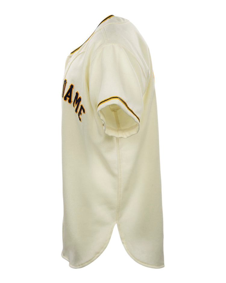The EFF University of Notre Dame 1956 Home Jersey is a cream, short-sleeve flannel with gold and black sleeve trim and partial chest text, shown side-on against a white background.