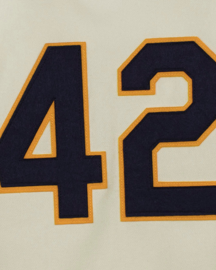 Featuring the number 42 in bold black with a gold outline on cream fabric, the EFF University of Notre Dame 1956 Home Jersey captures the authentic look of classic flannel baseball uniforms.