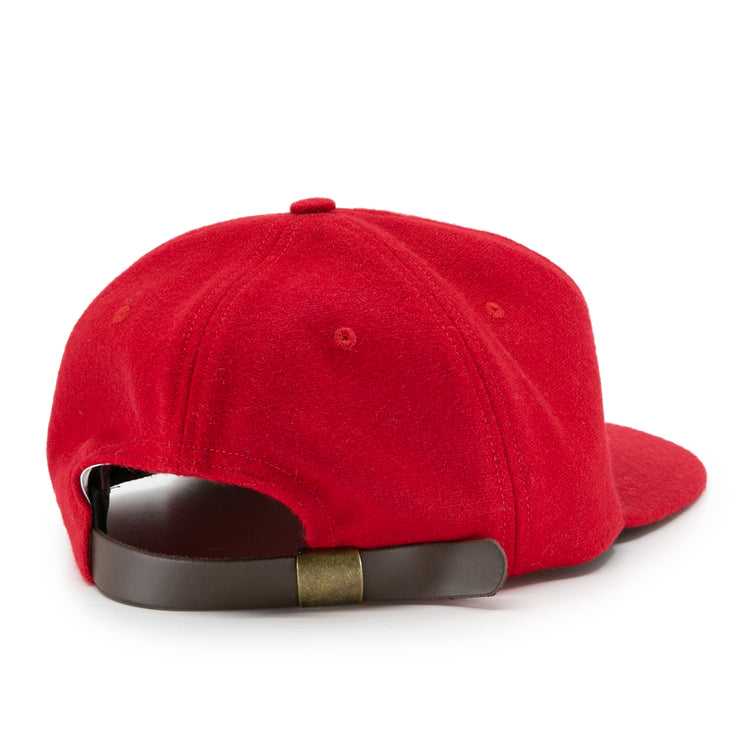 The Ebbets Field Flannels University of Nebraska 1958 Vintage Ballcap is red and shown from the back, featuring a brown adjustable leather strap with a brass buckle.