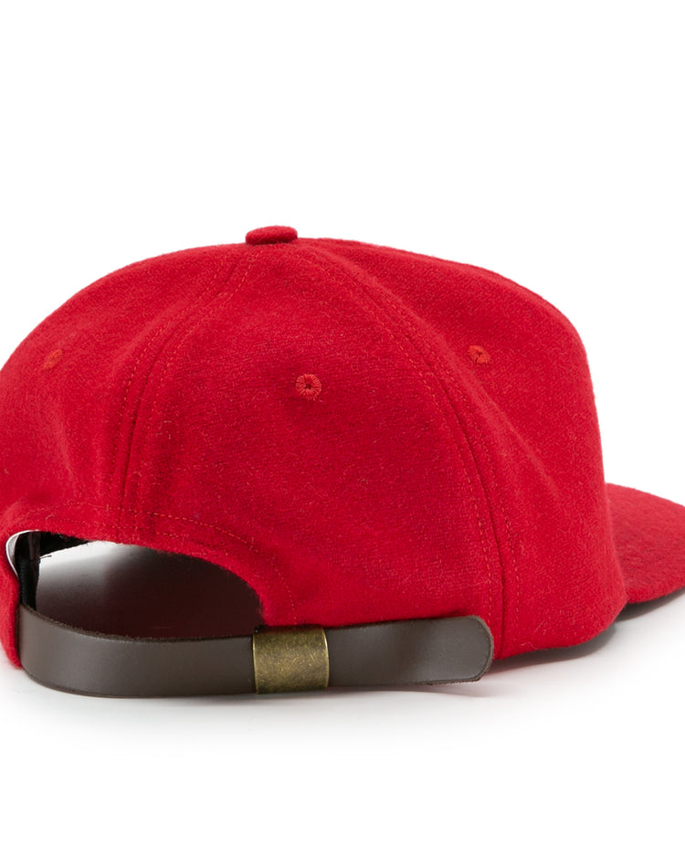 The Ebbets Field Flannels University of Nebraska 1958 Vintage Ballcap is red and shown from the back, featuring a brown adjustable leather strap with a brass buckle.