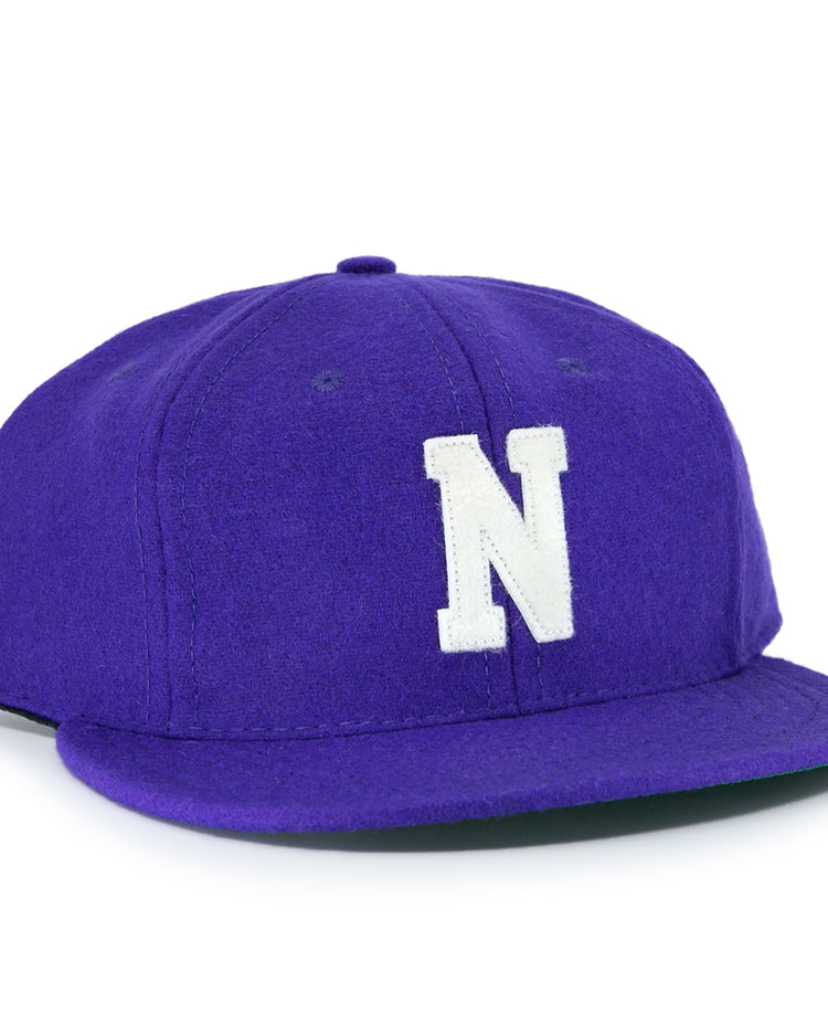 The EFF Northwestern University 1961 Vintage Ballcap is a purple wool flat-brim cap with a large white N embroidered on the front, inspired by the officially licensed college vault design.