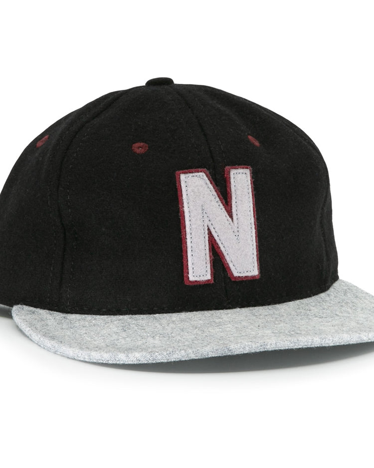 The EFF Nashville Stars 2021 Road Ballcap features a black crown, light gray brim, and a large white “N” with a maroon outline on the front, honoring the legacy of Negro Leagues baseball caps.