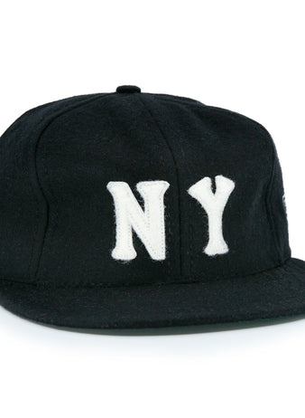 The EFF New York Black Yankees Vintage Inspired Ballcap is a black hat featuring bold white NY letters on the front, offering a classic vintage look.