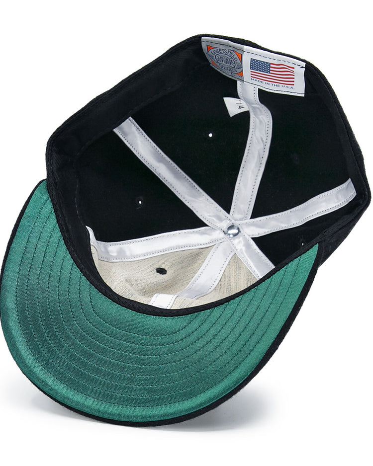 Inside the New York Black Yankees Vintage Inspired Ballcap by EFF: a green underbrim, black fabric, white sweatband, and a label with an American flag and Made in the USA text.