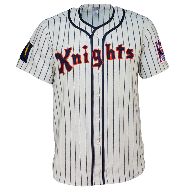 The EFF New York Knights 1939 Home Jersey features white fabric, vertical navy stripes, red Knights lettering, and sleeve patches—ideal for a Roy Hobbs costume or any fan of The Natural.