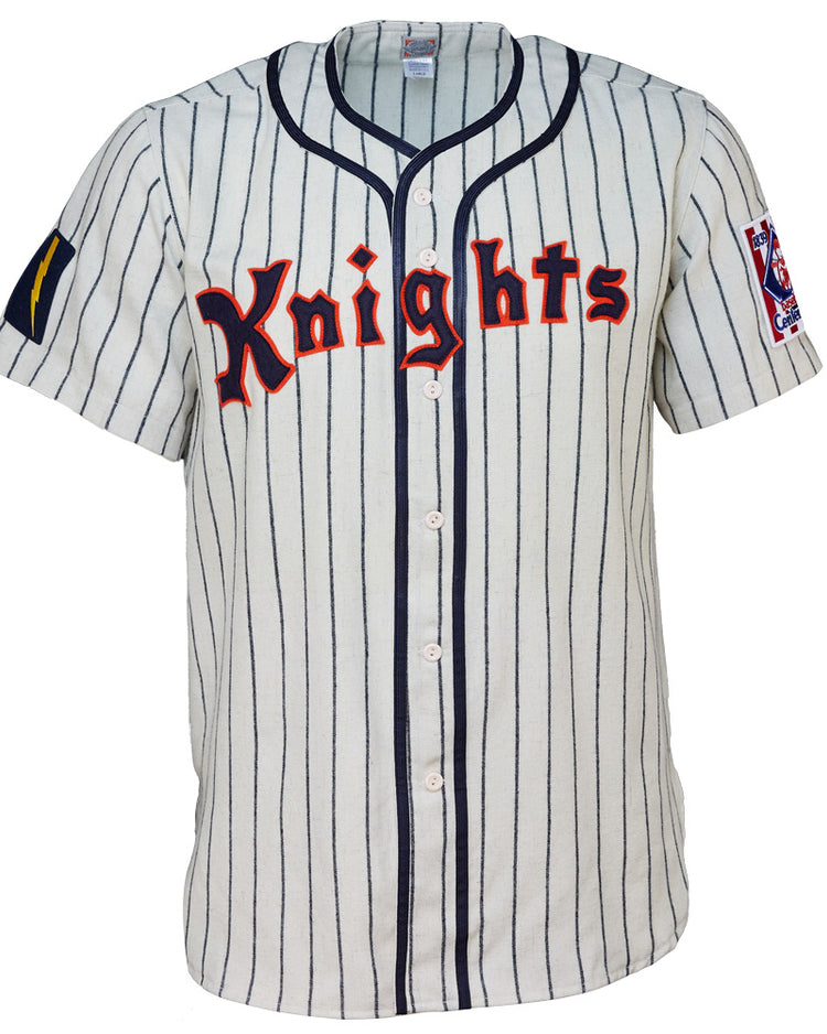 The EFF New York Knights 1939 Home Jersey features white fabric, vertical navy stripes, red Knights lettering, and sleeve patches—ideal for a Roy Hobbs costume or any fan of The Natural.