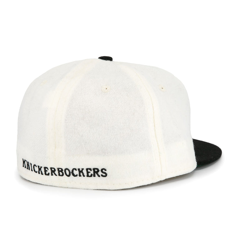 The EFF New York Knickerbockers Vintage Inspired Ballcap features a white crown, black brim, and KNICKERBOCKERS embroidered in black above the adjustable band for classic NYC style.