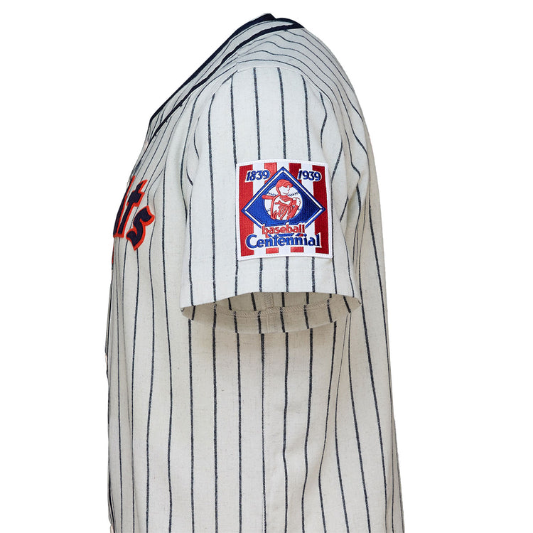 The EFF New York Knights 1939 Home Jersey features vintage white fabric with navy pinstripes, red lettering, and a “1839 1939 Baseball Centennial” sleeve patch—just like the jersey worn by Roy Hobbs in The Natural.