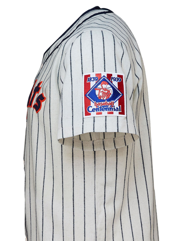 The EFF New York Knights 1939 Home Jersey features vintage white fabric with navy pinstripes, red lettering, and a “1839 1939 Baseball Centennial” sleeve patch—just like the jersey worn by Roy Hobbs in The Natural.