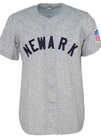 The EFF Newark Bears 1942 Road Jersey features gray baseball flannel, NEWARK in black across the chest, a blue, red, and white patch on the left sleeve, and classic button-up styling for authentic International League flair.