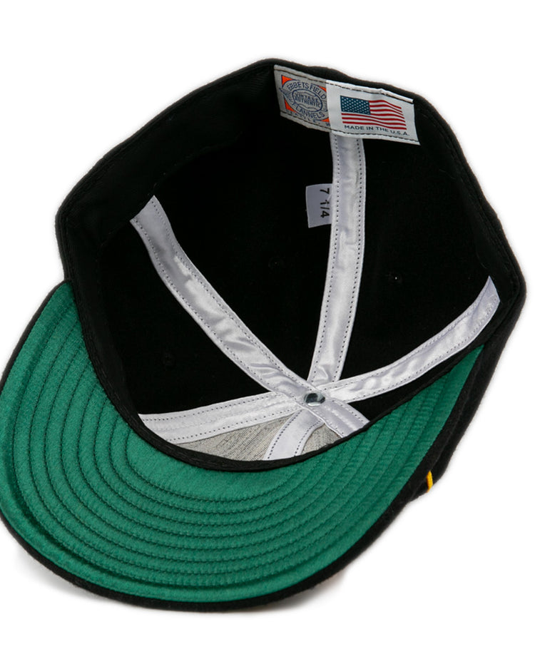 The inside of this EFF Oakland Caskets Co. 1938 Vintage Ballcap features a green underbrim, white lining, and an American flag tag marked “Made in U.S.A.” with size “7 1/4”—a timeless classic.