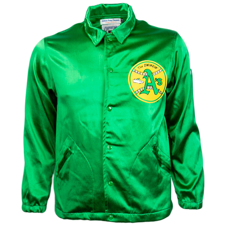 The EFF Oakland As 1971 Satin Windbreaker features bright green satin, snap buttons, side pockets, and a circular yellow patch with The Swingin’ A’s logo on the chest—perfect for fans of MLB vintage style.