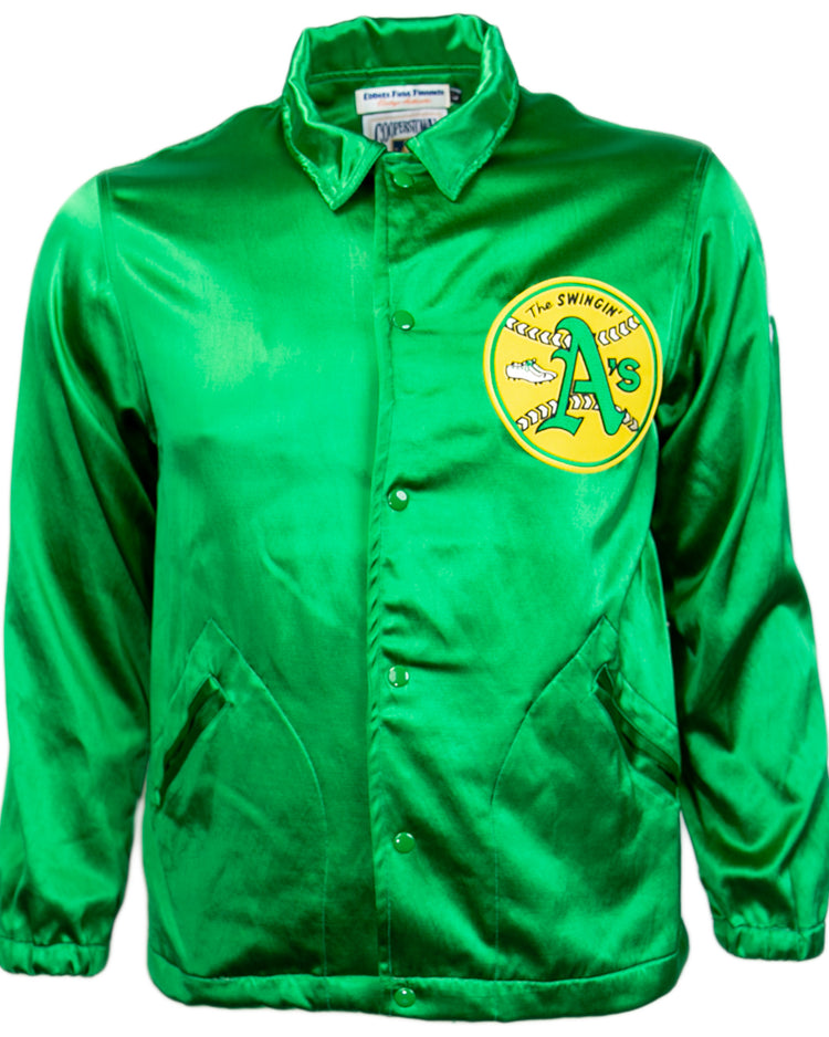 The EFF Oakland As 1971 Satin Windbreaker features bright green satin, snap buttons, side pockets, and a circular yellow patch with The Swingin’ A’s logo on the chest—perfect for fans of MLB vintage style.