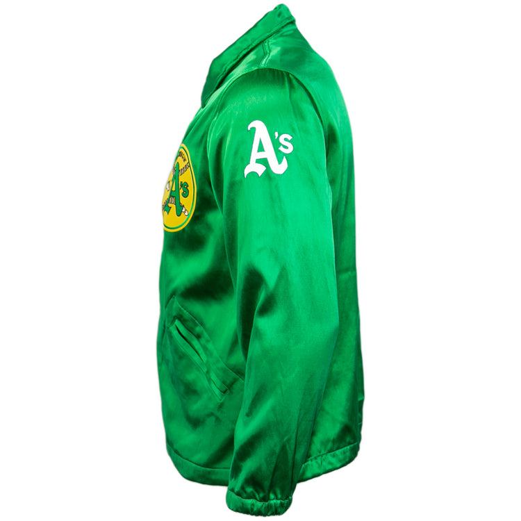 The EFF Oakland As 1971 Satin Windbreaker features a green satin finish, front elephant logo, As lettering on the left sleeve, and vintage MLB style—shown here from a side angle.