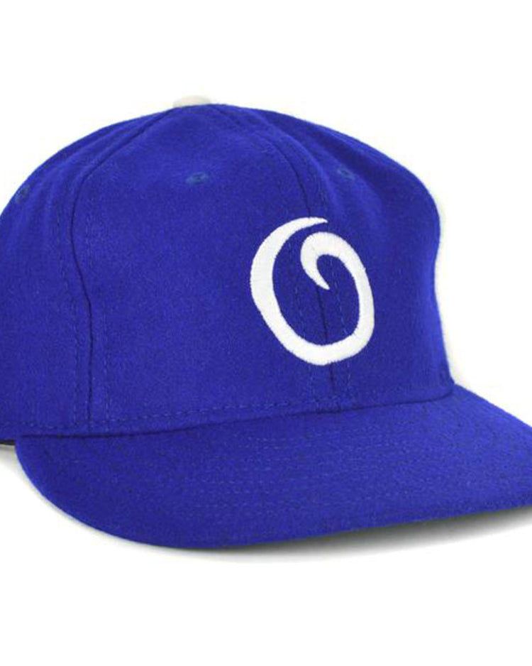 The EFF Oakland Oaks 1950 Vintage Ballcap is a royal blue cap featuring a white, stylized “O” on the front, inspired by the classic Pacific Coast League teams design.