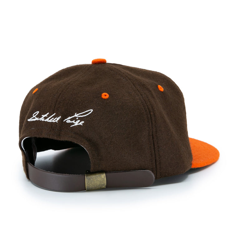The Satchel Paige 1952 Signature Series Ballcap by Ebbets Field Flannels is a brown and orange vintage wool cap with a brown adjustable strap, metal clasp, and white embroidered script on the back—a classic nod to the Negro Leagues.