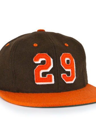 The Ebbets Field Flannels Satchel Paige 1952 Signature Series Ballcap is a vintage brown wool cap with an orange brim and “29” in orange with a white outline, honoring the legendary Negro Leagues pitcher.