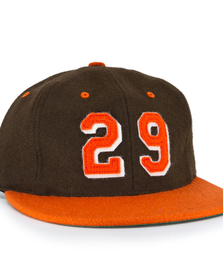 The Ebbets Field Flannels Satchel Paige 1952 Signature Series Ballcap is a vintage brown wool cap with an orange brim and “29” in orange with a white outline, honoring the legendary Negro Leagues pitcher.