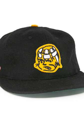 The EFF Pittsburgh Hornets 1953 Vintage Ballcap is a black wool hat featuring a yellow embroidered cartoon face on the front and American and Japanese flags on the side, inspired by classic Hornets style.