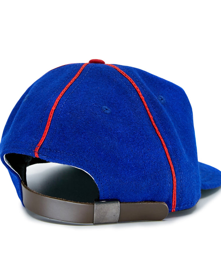 The EFF Phoenix Senators 1930 Vintage Ballcap is a blue wool cap with red seam stitching, featuring an adjustable brown strap and metallic clasp, inspired by the classic Arizona State League team.