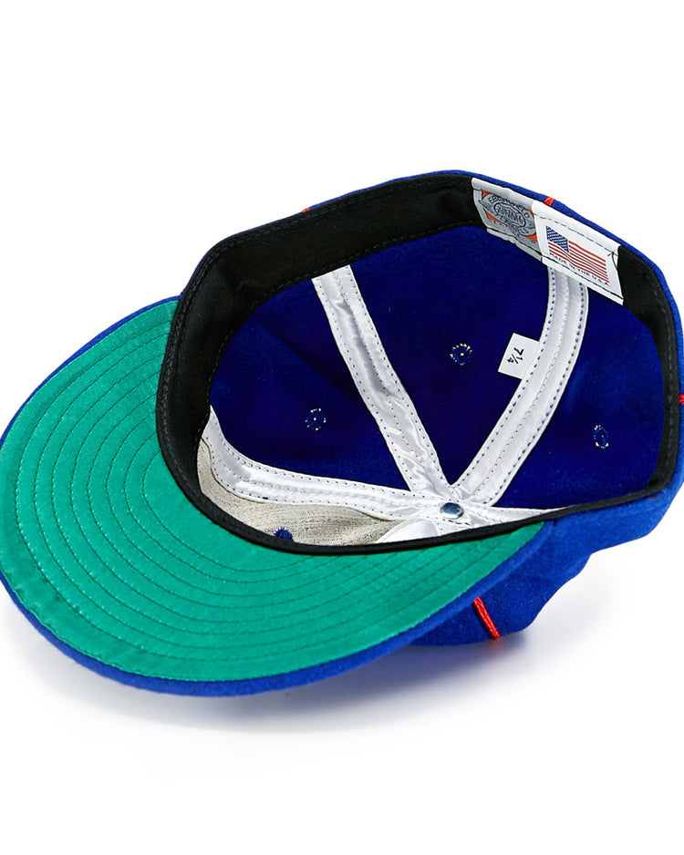 The EFF Phoenix Senators 1930 Vintage Ballcap in blue wool is shown inside out, displaying its green brim underside, white lining, black sweatband, size tag, and Made in USA label—true to the original Arizona State League style.