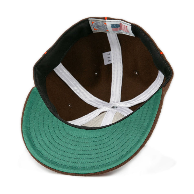 A close-up of the Pocatello Bannocks 1952 Vintage Ballcap by EFF shows its green underside brim, white lining, American flag tag, and a 7 1/4 size label—highlighting the classic wool charm of this retro baseball hat.
