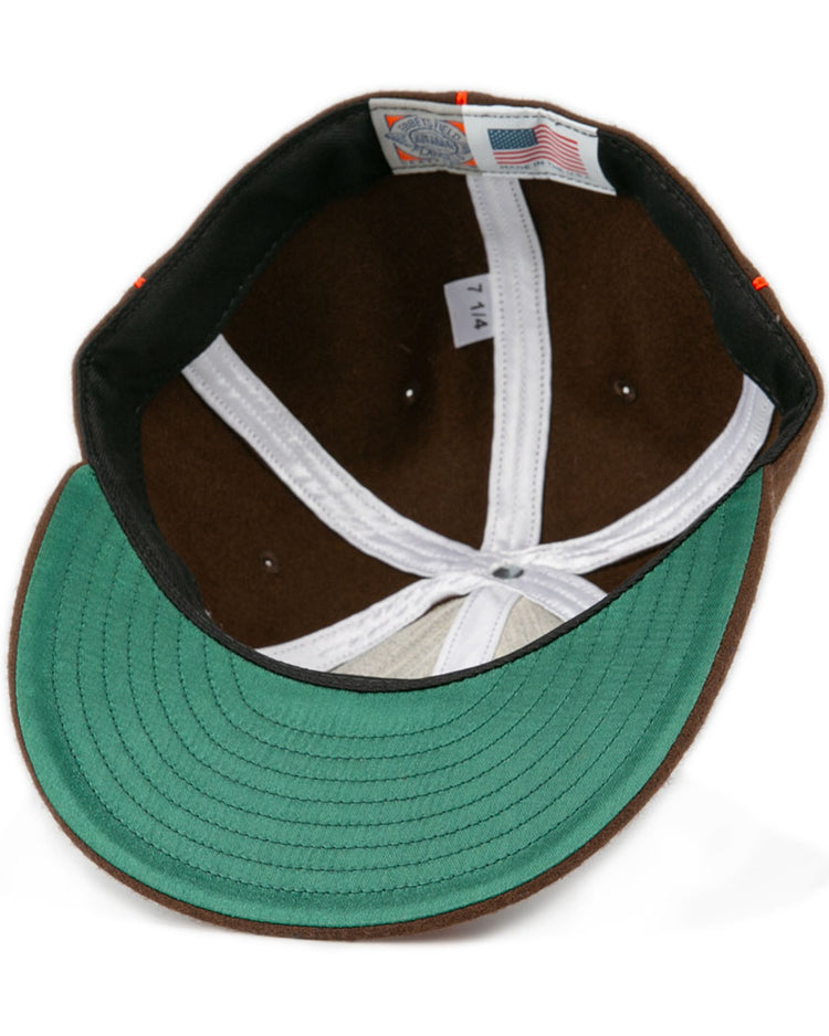 A close-up of the Pocatello Bannocks 1952 Vintage Ballcap by EFF shows its green underside brim, white lining, American flag tag, and a 7 1/4 size label—highlighting the classic wool charm of this retro baseball hat.