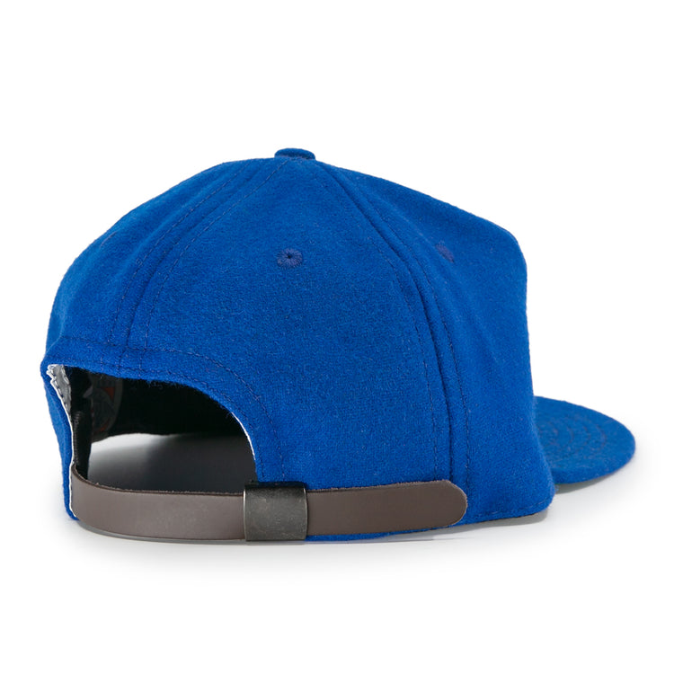 The EFF Puerto Rico Marlins 1961 Vintage Ballcap is a blue wool hat with a curved brim and an adjustable leather strap, styled after classic baseball caps and inspired by the original Marlins design.