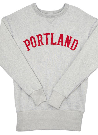 The EFF Portland Beavers Crewneck Sweatshirt is a light gray French terry vintage-cut top with PORTLAND in bold red letters across the chest, plus ribbed cuffs and hem for comfort.