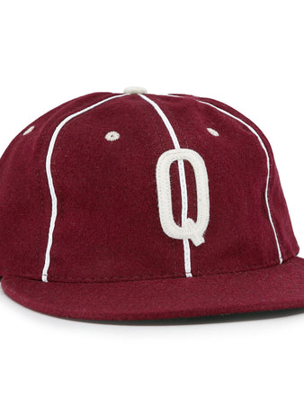 The EFF Quebec Athletics 1941 Vintage Ballcap is crafted from genuine wool in maroon with white piping, a flat brim, a classic top button, and features a bold white letter Q embroidered on the front.