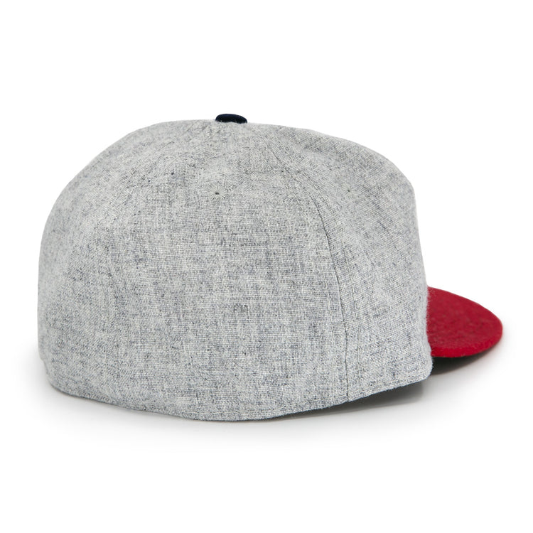 The Regina Nationals 1933 Vintage Ballcap by Ebbets Field Flannels is shown from the back, featuring a gray body, red brim, visible seam details, and a classic vintage design.