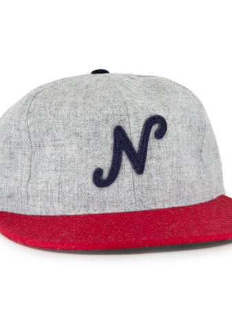 The Regina Nationals 1933 Vintage Ballcap by Ebbets Field Flannels is made from authentic wool, with a gray crown, red brim, and a dark blue cursive N on the front—faithfully recreating the original 1933 design.