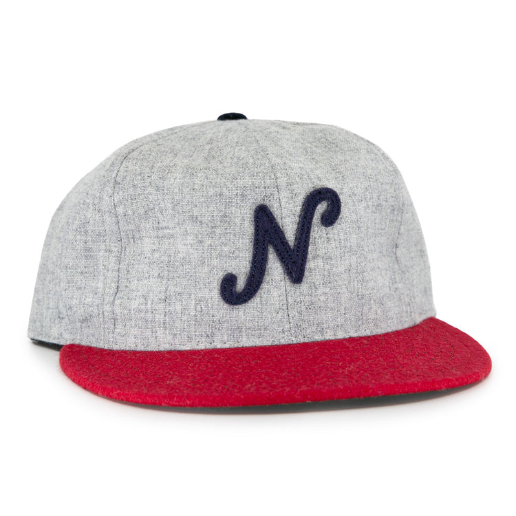 The Regina Nationals 1933 Vintage Ballcap by Ebbets Field Flannels is made from authentic wool, with a gray crown, red brim, and a dark blue cursive N on the front—faithfully recreating the original 1933 design.