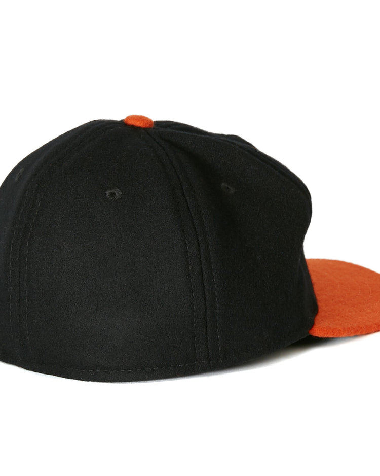 The EFF Richmond Virginians 1955 Vintage Ballcap, a black wool cap with orange brim and button, is displayed from the back and side against a white background.