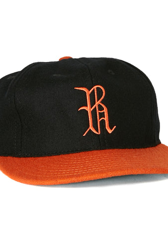 The EFF Richmond Virginians 1955 Vintage Ballcap is a black wool baseball cap featuring an orange brim and an orange embroidered R logo on the front, inspired by the classic 1955 design.